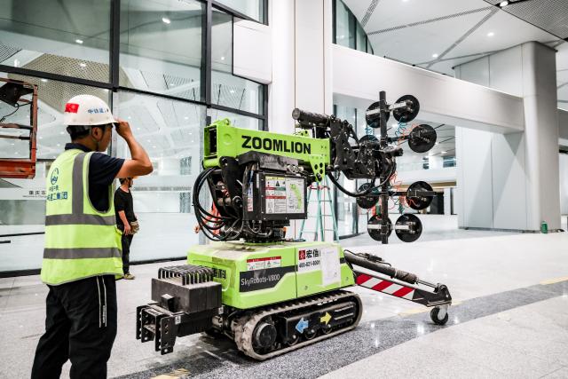 (250703) -- CHONGQING, July 3, 2025 (Xinhua) -- A technician with China Railway Construction Engineering Group debugs a glass curtain wall installation robot at the construction site of Chongqing East Railway Station, in southwest China's Chongqing, on June 21, 2025. As the new section of the Chongqing-Xiamen high-speed railway, from Chongqing to Qianjiang, officially opened a week ago, the key hub along this route, Chongqing East Railway Station, was also put into operation.
   From obtaining the design blueprints in May 2022 to its official inauguration, it has taken 38 months to complete what is now the largest high-speed rail station in west China. Behind this monumental construction project are a group of unsung heroes -- robots.
   TO GO WITH "China Focus: A robot revolution in building the largest railway station in west China" (China Railway Construction Engineering Group/Handout via Xinhua)