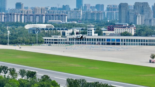 (250703) -- HEFEI, July 3, 2025 (Xinhua) -- A drone photo taken on July 2, 2025 shows an electric vertical take-off-and-landing (eVTOL) aircraft performing flight demonstration at Luogang Park in Hefei, east China's Anhui Province. In alignment with the national strategy to cultivate industries of the future, Hefei is forging ahead with strategic layouts in emerging frontiers like quantum information, low-altitude economy, commercial aerospace, fusion energy, artificial intelligence, intelligent robotics, and biosynthetic manufacturing to accelerate industrial cluster formation. The city has achieved remarkable progress across multiple future industry sectors, emerging as a robust hub of rapid advancement. (Xinhua/Zhou Mu)