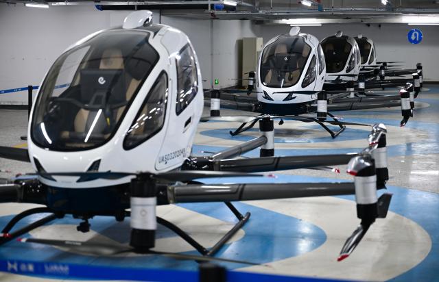 (250703) -- HEFEI, July 3, 2025 (Xinhua) -- This photo shows electric vertical take-off-and-landing (eVTOL) aircraft parking in a charging hangar at Luogang Park in Hefei, east China's Anhui Province, July 2, 2025. In alignment with the national strategy to cultivate industries of the future, Hefei is forging ahead with strategic layouts in emerging frontiers like quantum information, low-altitude economy, commercial aerospace, fusion energy, artificial intelligence, intelligent robotics, and biosynthetic manufacturing to accelerate industrial cluster formation. The city has achieved remarkable progress across multiple future industry sectors, emerging as a robust hub of rapid advancement. (Xinhua/Zhou Mu)