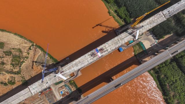 (250703) -- ZHONGWEI, July 3, 2025 (Xinhua) -- An aerial drone photo taken on July 3, 2025 shows the Heishan Gorge Yellow River grand bridge in Zhongwei City, northwest China's Ningxia Hui Autonomous Region. The two sides of the Heishan Gorge Yellow River grand bridge were joined together on Thursday, laying a solid foundation for the bridge's completion within this year.
  The 1,539-meter-long grand bridge, with a span of 240 meters, is a major project of the highway linking Zhongwei of northwest China's Ningxia Hui Autonomous Region and Mengjiawan of northwest China's Shaanxi Province. (Xinhua/Feng Kaihua)