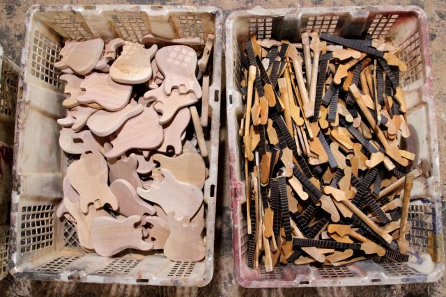 (250703) -- KLATEN, July 3, 2025 (Xinhua) -- Parts of miniature guitars are seen at a handicraft workshop in Klaten Regency, Central Java, Indonesia, on July 3, 2025. Those miniature guitars are made from mahogany, aluminum, fiber, resin and strings. (Photo by Bram Selo/Xinhua)