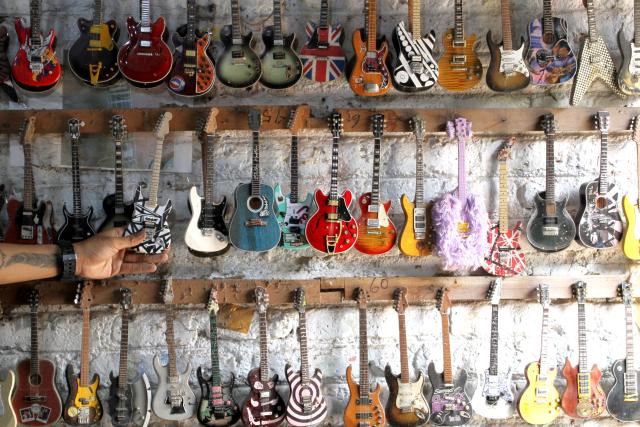 (250703) -- KLATEN, July 3, 2025 (Xinhua) -- Miniature guitar collections are seen at a handicraft workshop in Klaten Regency, Central Java, Indonesia, on July 3, 2025. Those miniature guitars are made from mahogany, aluminum, fiber, resin and strings. (Photo by Bram Selo/Xinhua)