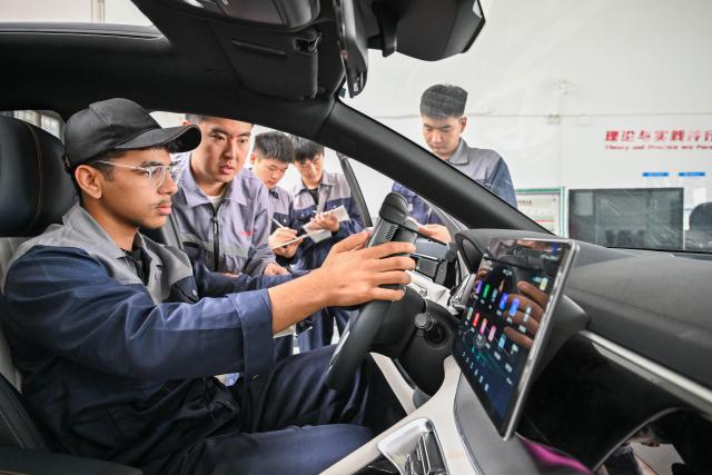 (250704) -- TIANJIN, July 4, 2025 (Xinhua) -- Mostafa Salah (L) diagnoses faults in a new energy vehicle with the guidance of his teacher Zhou Fan at a training center of Tianjin Transportation Technical College in Tianjin, north China, June 27, 2025.
  20-year-old Mostafa Salah, whose Chinese name is Guo Zhenkai, is one of the first batch of Egyptian Luban Workshop graduates at Tianjin Transportation Technical College. 
   In 2024, after graduating from the Luban Workshop at the Advanced Technical School for Maintenance Technology in Cairo, Salah chose to continue his studies in new energy vehicle technology and came to Tianjin. 
   "The training equipment in both countries is highly compatible. China's new energy vehicle industry is thriving, and here I can learn cutting-edge knowledge and hands-on experience," Salah said. 
   With the guidance of his Chinese teachers and the help of classmates, Salah is now capable of operating equipment independently and has acquired skills in diagnosing and repairing faults in new energy vehicles after a year of training.
   Today, an increasing number of Chinese-brand new energy vehicles can be seen on the streets of Egypt, and many Chinese enterprises invest in factories in Egypt. 
   "Learning new energy vehicle technology gives us a more promising career when we return to our hometown," Salah said. 
   As of June this year, the Luban Workshop operated by Tianjin Transportation Technical College and the Advanced Technical School for Maintenance Technology in Cairo has trained over 2,000 Egyptian teachers and students, contributing skilled technical talent to support the development of Egypt's automotive industry. (Xinhua/Sun Fanyue)