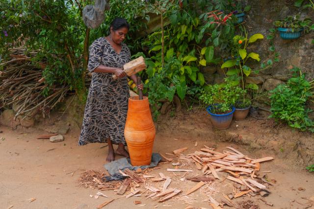 (250704) -- KADUGANNAWA, July 4, 2025 (Xinhua) -- A woman processes the barrel of a traditional drum in Kadugannawa, Sri Lanka, July 3, 2025. The central region of Sri Lanka, especially Kadugannawa, is famous for the making and use of traditional wooden drums, which play an important role in Sri Lankan rituals and dances. (Photo by Thilina Kaluthotage/Xinhua)