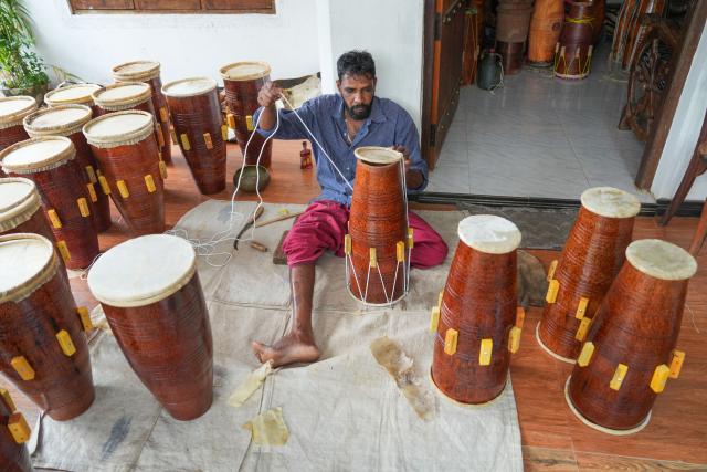 (250704) -- KADUGANNAWA, July 4, 2025 (Xinhua) -- A man assembles a traditional drum in Kadugannawa, Sri Lanka, July 3, 2025. The central region of Sri Lanka, especially Kadugannawa, is famous for the making and use of traditional wooden drums, which play an important role in Sri Lankan rituals and dances. (Photo by Thilina Kaluthotage/Xinhua)