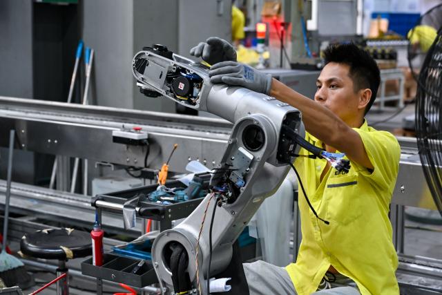 (250704) -- WUHU, July 4, 2025 (Xinhua) -- A staff member assembles a robot at Anhui Efort Intelligent Equipment Co., Ltd. in Wuhu, east China's Anhui Province, July 3, 2025.
  Founded in 2007, Anhui Efort Intelligent Equipment Co., Ltd. produces robots widely used in industries such as electronics, photovoltaics, lithium batteries, automotive and auto parts, rail transit, and shipbuilding. 
   The company established a comprehensive R&D system for core technologies, having achieved a 100% ratio in localization and self-sufficiency for critical components. It sold over 16,000 industrial robots in 2024.
   As the first national-level robotics industry cluster in the country, Wuhu is home to more than 300 enterprises along the robotics supply chain. The city's robotics industry output exceeded 40 billion yuan (about 5.58 billion U.S. dollars) in 2024. (Xinhua/Zhang Cheng)