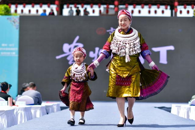 (250704) -- GUIYANG, July 4, 2025 (Xinhua) -- People participate in the "Village T," an ethnic costume show, in Taijiang County, southwest China's Guizhou Province, April 13, 2025. (Xinhua/Yang Wenbin)