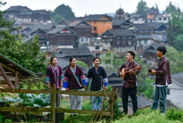 (250704) -- GUIYANG, July 4, 2025 (Xinhua) -- Yang Xiangni (3rd L) and her team member practice a song of the Dong ethnic group in Zhaoxing Town of Liping County, southwest China's Guizhou Province, April 23, 2025. (Xinhua/Yang Wenbin)