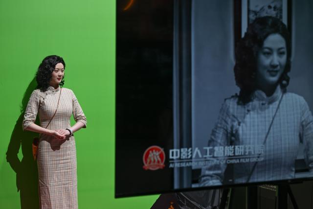 (250704) -- CHONGQING, July 4, 2025 (Xinhua) -- A staff member demonstrates AI face-changing technology at the Yongchuan International Convention and Exhibition Center in southwest China's Chongqing, July 4, 2025. The 2025 SCO (the Shanghai Cooperation Organization) Film Festival takes place from July 3 to 7 here, attracting filmmakers from Russia, Belarus, Pakistan and other SCO member states to present their country's films. The event also gathered over 40 domestic film enterprises to present the latest advancements in film technology and production. 
Highlighting the latest advancements in film technology and production across member states, the event features 11 major activities, including film screenings, cooperation forums, a film technology exhibition, and a gala concert. (Xinhua/Chen Cheng)