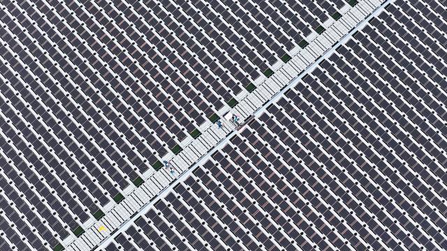 (250704) -- QINGDAO, July 4, 2025 (Xinhua) -- An aerial drone photo taken on July 4, 2025 shows workers inspecting at the site of the floating offshore photovoltaic (PV) project of Sinopec Qingdao Refining & Chemical Co., Ltd. in Qingdao, east China's Shandong Province. The project was connected to the grid for electricity generation recently. Located in the Xihai'an (West Coast) New Area of the east China's coastal city, the project innovatively adopts a floating structure, with the photovoltaic panels rising and falling close to the water surface with the tide, and uses seawater to efficiently dissipate heat to improve power generation efficiency. With an installed capacity of 7.5 megawatts, it is expected to generate nearly 10 million kilowatt-hours of green electricity annually and reduce carbon dioxide emissions by 8,300 tons. Since it was put into use on July 1, the project has generated a total of 123,100 kilowatt-hours of electricity. (Photo by Zhang Jingang/Xinhua)