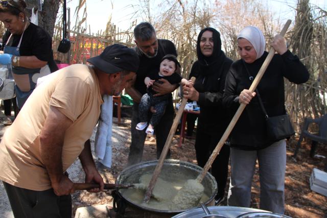(250704) -- KHIAM, July 4, 2025 (Xinhua) -- Residents prepare the traditional dish Harissa Marwath in Khiam, Lebanon, on July 3, 2025. It is a custom for Shiite residents in Khiam to prepare Harissa Marwath during Ashura. The dish is made from wheat, water, ghee, meat and chicken, and is distributed to passers-by as part of the commemorative ritual. (Photo by Taher Abu Hamdan/Xinhua)