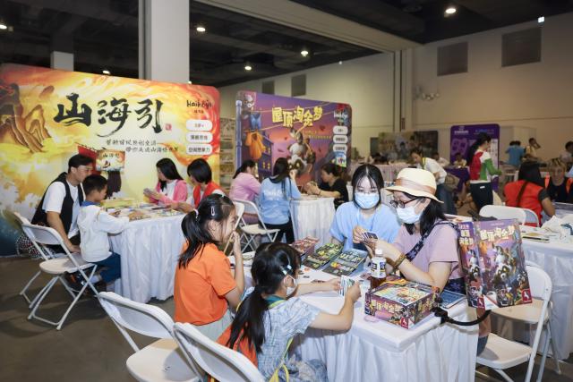 (250704) -- SHANGHAI, July 4, 2025 (Xinhua) -- People play card games during the China International Cartoon & Game Expo 2025 (CCG Expo 2025) in east China's Shanghai, July 4, 2025. The CCG Expo 2025 kicked off Friday at the Shanghai Convention and Exhibition Center of International Sourcing with the participation of 480 domestic and international exhibitors. The event will last until July 6. (Xinhua/Wang Xiang)