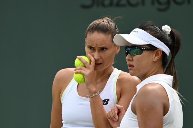 (250704) -- LONDON, July 4, 2025 (Xinhua) -- Guo Hanyu/Alexandra Panova (L) react during the women's doubles second round match between Guo Hanyu (China)/Alexandra Panova (Russia) and Timea Babos (Hungary)/Luisa Stefani (Brazil) at the Wimbledon Tennis Championships in London, Britain, July 4, 2025. (Xinhua/Li Ying)