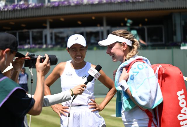(250704) -- LONDON, July 4, 2025 (Xinhua) -- Zhang Shuai and Ekaterina Alexandrova (R) receive an interview after the women's doubles second round match between Zhang Shuai (China)/Ekaterina Alexandrova (Russia) and Hozumi Eri (Japan)/Aldila Sutjiadi (Indonesia) at the Wimbledon Tennis Championships in London, Britain, July 4, 2025. (Xinhua/Li Ying)