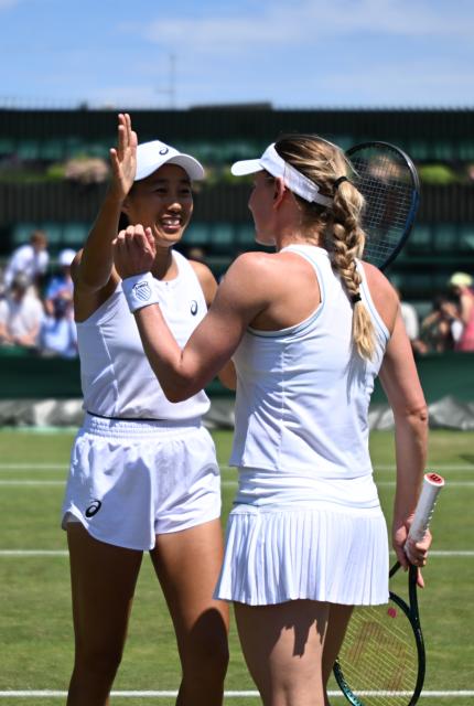 (250704) -- LONDON, July 4, 2025 (Xinhua) -- Zhang Shuai (L) celebrates with Ekaterina Alexandrova after the women's doubles second round match between Zhang Shuai (China)/Ekaterina Alexandrova (Russia) and Hozumi Eri (Japan)/Aldila Sutjiadi (Indonesia) at the Wimbledon Tennis Championships in London, Britain, July 4, 2025. (Xinhua/Li Ying)