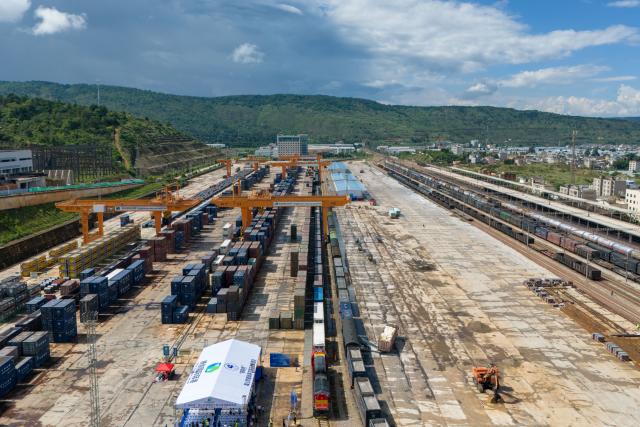 (250704) -- KUNMING, July 4, 2025 (Xinhua) -- An aerial drone photo shows the first train of the "Zheng He" Sea-Road-Rail International Multimodal Transport Service waiting for departure at Tengjun International Land Port in Kunming, capital of southwest China's Yunnan Province, July 4, 2025. The train left Kunming on Friday. After arriving in Vientiane of Laos via the China-Laos Railway, the goods will be transported to Thailand, Singapore and Bangladesh through other three routes. (Xinhua/Peng Yikai)