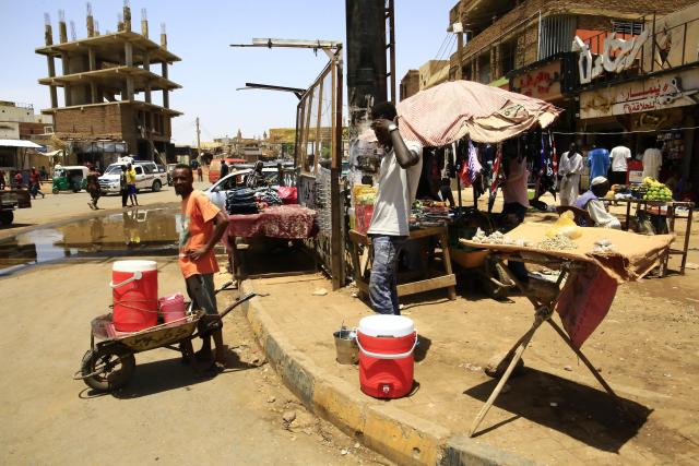 (250704) -- OMDURMAN (SUDAN), July 4, 2025 (Xinhua) -- People wait for customers at a market in Omdurman city, north of Khartoum, Sudan, on July 3, 2025. After more than two years of devastating conflict, Sudan's capital Khartoum is slowly emerging from the ruins of war, inching toward a return to normal life. (Photo by Mohamed Khidir/Xinhua) TO GO WITH Feature: Sudan's Khartoum strives to recover amid ongoing civil war
