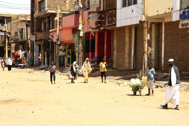(250704) -- OMDURMAN (SUDAN), July 4, 2025 (Xinhua) -- People are seen on a street in Omdurman city, north of Khartoum, Sudan, on July 3, 2025. After more than two years of devastating conflict, Sudan's capital Khartoum is slowly emerging from the ruins of war, inching toward a return to normal life. (Photo by Mohamed Khidir/Xinhua) TO GO WITH Feature: Sudan's Khartoum strives to recover amid ongoing civil war