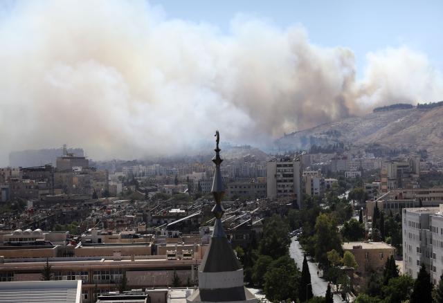 (250705) -- DAMASCUS, July 5, 2025 (Xinhua) -- Smoke rises as a result of a fire that erupted near the Syrian al-Shaab presidential palace in Damascus, Syria, July 4, 2025. Unknown fire erupted Friday afternoon in bushes close to the Syrian al-Shaab presidential palace situated on top of a mountain overlooking the capital Damascus, sending thick plums of black smoke over wide areas, local media and witnesses said. (Photo by Ammar Safarjalani/Xinhua)