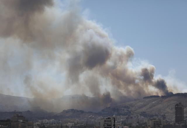 (250705) -- DAMASCUS, July 5, 2025 (Xinhua) -- Smoke rises as a result of a fire that erupted near the Syrian al-Shaab presidential palace in Damascus, Syria, July 4, 2025. Unknown fire erupted Friday afternoon in bushes close to the Syrian al-Shaab presidential palace situated on top of a mountain overlooking the capital Damascus, sending thick plums of black smoke over wide areas, local media and witnesses said. (Photo by Ammar Safarjalani/Xinhua)