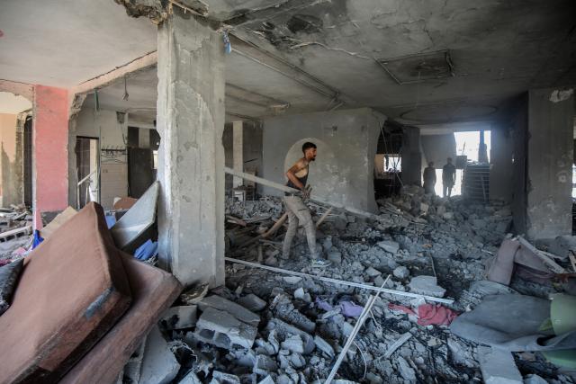 (250705) -- GAZA, July 5, 2025 (Xinhua) -- Palestinians inspect a destroyed house after an Israeli airstrike in the al-Shati refugee camp, west of Gaza City, on July 4, 2025. (Photo by Rizek Abdeljawad/Xinhua)