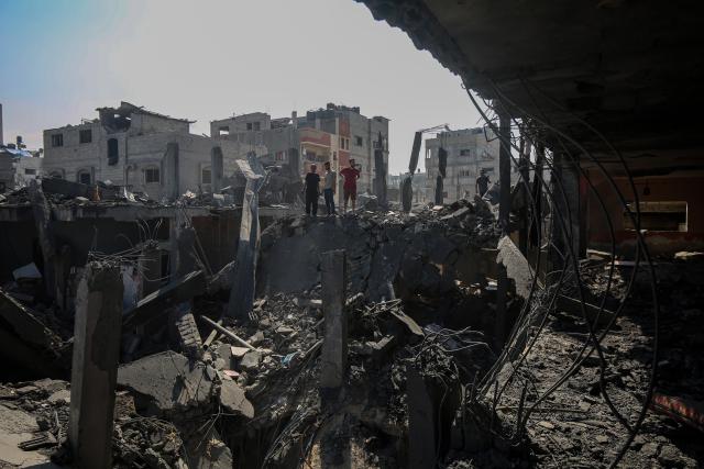 (250705) -- GAZA, July 5, 2025 (Xinhua) -- Palestinians inspect destroyed houses after an Israeli airstrike in the al-Shati refugee camp, west of Gaza City, on July 4, 2025. (Photo by Rizek Abdeljawad/Xinhua)