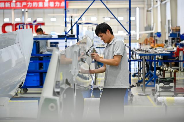 (250705) -- WUHU, July 5, 2025 (Xinhua) -- A worker assembles the wing of a general aviation aircraft at the workshop of CETC Wuhu Diamond Aircraft Manufacture Co., Ltd. in Wuhu City, east China's Anhui Province, July 3, 2025. In recent years, Anhui Province has accelerated the layout of its aerospace information industry, which encompasses low-altitude economy, commercial space, satellite applications, and deep space exploration. From booming "low altitude economy" such as drone delivery and low-altitude tourism, to the aggregation of enterprises into a commercial space industry chain, and the accelerating development of deep space exploration, Anhui further enhanced its independent innovation capabilities, and elevated aerospace information industry into a new growth pole for its economic development. (Xinhua/Zhang Cheng)