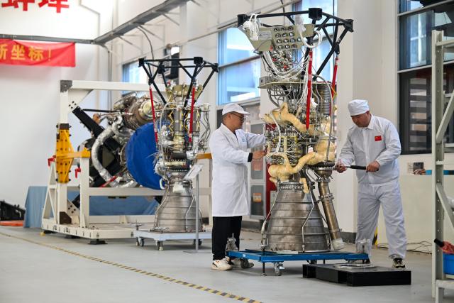 (250705) -- BENGBU, July 5, 2025 (Xinhua) -- Technicians inspect the liquid rocket engine that is about to be delivered at Jiuzhou Yunjian, an aerospace technology enterprise, in Bengbu City, east China's Anhui Province, March 11, 2024. In recent years, Anhui Province has accelerated the layout of its aerospace information industry, which encompasses low-altitude economy, commercial space, satellite applications, and deep space exploration. From booming "low altitude economy" such as drone delivery and low-altitude tourism, to the aggregation of enterprises into a commercial space industry chain, and the accelerating development of deep space exploration, Anhui further enhanced its independent innovation capabilities, and elevated aerospace information industry into a new growth pole for its economic development. (Photo by Huang Yangyang/Xinhua)