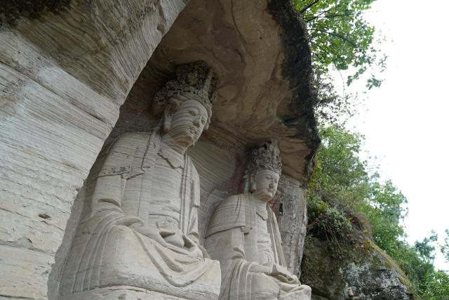 (250705) -- ZIYANG, July 5, 2025 (Xinhua) -- This photo shows stone carvings at Mingshan Temple in Shiyang Town of Ziyang City, southwest China's Sichuan Province, June 14, 2025. On top of Hutou Mountain in Shiyang Town of Ziyang City, a 76-year-old man named Zeng Xiangyu is a familiar sight to locals. Accompanied by his dog, he patrols the circular path around Mingshan Temple, meticulously inspecting each stone carving.
   Dating back to the Tang Dynasty (618-907), Mingshan Temple houses over 60 statues inside 13 caves. Most of these magnificent works of artistry were chiseled during the Song Dynasty (960-1127).
   In the 1980s, Zeng first came to the mountain with his uncle for temple renovation work. Since then, he has devoted his life to safeguarding these relics. When Mingshan Temple was listed as a national key cultural relics protection site in 2006, Zeng formally became its on-site cultural heritage administrator.
   Today, as visitors flock to Mingshan Temple, Zeng occasionally steps into a part-time role as a guide, narrating centuries-old tales. He has expressed that he wishes to protect these sculptural treasures passed down from ancestors to future generations. (Xinhua/Xu Bingjie)