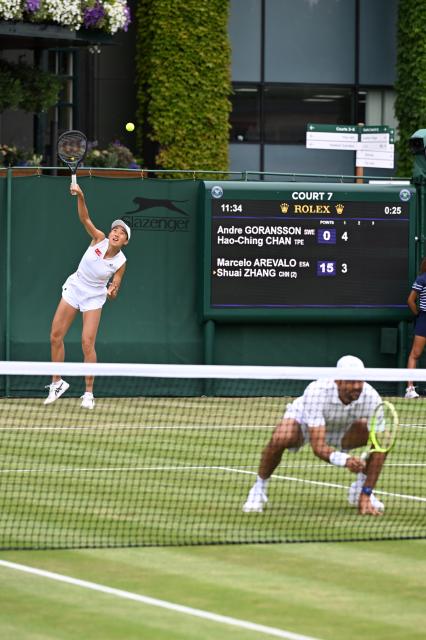 (250705) -- LONDON, July 5, 2025 (Xinhua) -- Zhang Shuai (L)/Marcelo Arevalo compete during the mixed doubles first round match between Zhang Shuai of China/Marcelo Arevalo of El Salvador and Chan Hao-Ching of Chinese Taipei/Andre Goransson of Sweden at the Wimbledon Tennis Championships in London, Britain, July 5, 2025. (Xinhua/Zhao Dingzhe)
