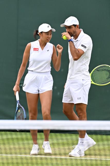 (250705) -- LONDON, July 5, 2025 (Xinhua) -- Zhang Shuai (L)/Marcelo Arevalo react during the mixed doubles first round match between Zhang Shuai of China/Marcelo Arevalo of El Salvador and Chan Hao-Ching of Chinese Taipei/Andre Goransson of Sweden at the Wimbledon Tennis Championships in London, Britain, July 5, 2025. (Xinhua/Zhao Dingzhe)
