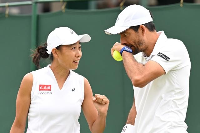 (250705) -- LONDON, July 5, 2025 (Xinhua) -- Zhang Shuai (L)/Marcelo Arevalo react during the mixed doubles first round match between Zhang Shuai of China/Marcelo Arevalo of El Salvador and Chan Hao-Ching of Chinese Taipei/Andre Goransson of Sweden at the Wimbledon Tennis Championships in London, Britain, July 5, 2025. (Xinhua/Zhao Dingzhe)