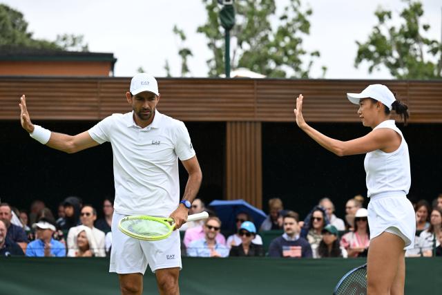 (250705) -- LONDON, July 5, 2025 (Xinhua) -- Zhang Shuai (R)/Marcelo Arevalo react during the mixed doubles first round match between Zhang Shuai of China/Marcelo Arevalo of El Salvador and Chan Hao-Ching of Chinese Taipei/Andre Goransson of Sweden at the Wimbledon Tennis Championships in London, Britain, July 5, 2025. (Xinhua/Zhao Dingzhe)