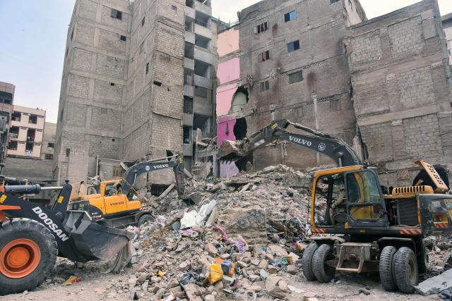 (250705) -- KARACHI, July 5, 2025 (Xinhua) -- Rescuers work at the scene of a residential building collapse in Karachi, Pakistan, on July 5, 2025. The death toll from the collapse of a residential building in Pakistan's southern port city of Karachi rose to 17 as more bodies were recovered from the debris, a spokesperson of the state-owned rescue organization Rescue 1122 told Xinhua on Saturday morning. (Xinhua)