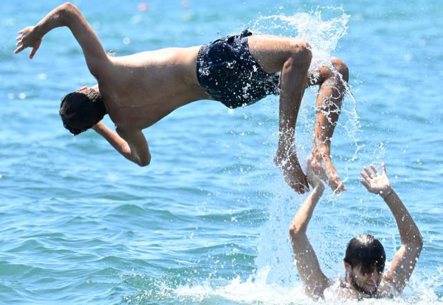 (250706) -- ROME, July 6, 2025 (Xinhua) -- People cool off in the sea during a heatwave in Ladispoli, Rome, Italy, July 5, 2025. (Photo by Alberto Lingria/Xinhua)