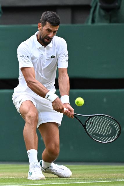 (250706) -- LONDON, July 6, 2025 (Xinhua) -- Novak Djokovic hits a return during the men's singles third round match between Novak Djokovic of Serbia and Miomir Kecmanovic of Serbia at the Wimbledon Tennis Championships in London, Britain, July 5, 2025. (Xinhua/Zhao Dingzhe)