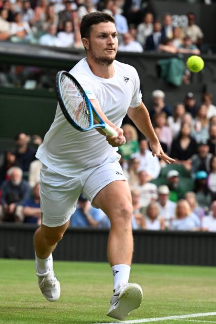 (250706) -- LONDON, July 6, 2025 (Xinhua) -- Miomir Kecmanovic hits a return during the men's singles third round match between Novak Djokovic of Serbia and Miomir Kecmanovic of Serbia at the Wimbledon Tennis Championships in London, Britain, July 5, 2025. (Xinhua/Zhao Dingzhe)