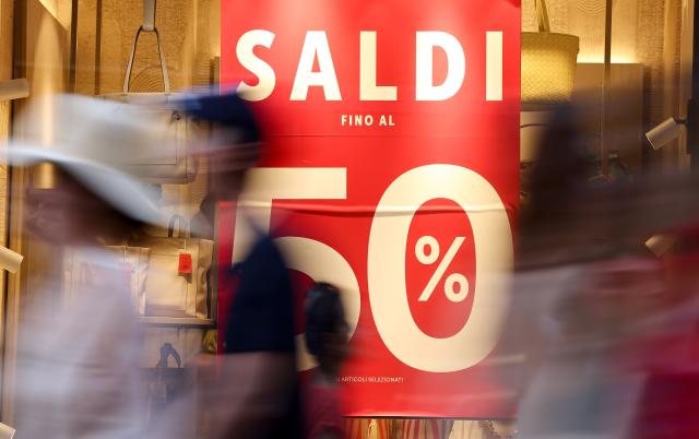 (250706) -- ROME, July 6, 2025 (Xinhua) -- People walk past a shop window in Rome, Italy, July 5, 2025. Italy's summer sales started on Saturday, running between six and eight weeks. (Xinhua/Li Jing)