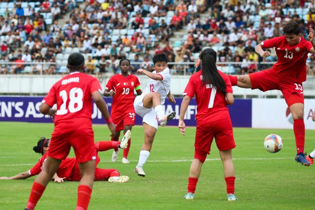 (250706) -- YANGON, July 6, 2025 (Xinhua) -- Win Win (C) of Myanmar shoots during the AFC Women's Asian Cup 2026 qualifiers Group C football match between Myanmar and Bahrain in Yangon, Myanmar, July 5, 2025. (Xinhua/Myo Kyaw Soe)