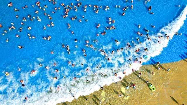 (250706) -- BEIJING, July 6, 2025 (Xinhua) -- An aerial drone photo taken on July 5, 2025 shows tourists enjoying themselves at a tourist resort in Huzhou City, east China's Zhejiang Province. With the arrival of summer vacation, many places in China have entered the peak tourist season. (Photo by Wu Zheng/Xinhua)
