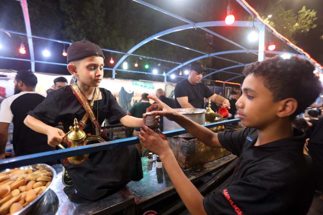 (250706) -- BAGHDAD, July 6, 2025 (Xinhua) -- People participate in commemorative activity on the occasion of Ashura, in Baghdad, Iraq, on July 5, 2025. Ashura takes place on the 10th day of Muharram, the first month in the Islamic lunar calendar. (Xinhua/Khalil Dawood)