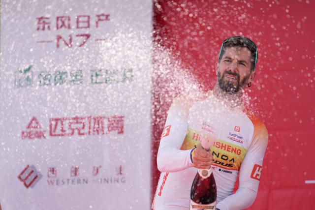 (250706) -- XINING, July 6, 2025 (Xinhua) -- Second placed Eduard-Michael Grosu of Huansheng-Vonoa-Taishan Sport Team celebrates on the podium after Stage 1 of the Tour of Magnificent Qinghai international road cycling race in Xining, northwest China's Qinghai Province, July 6, 2025. (Xinhua/Qi Zhiyue)
