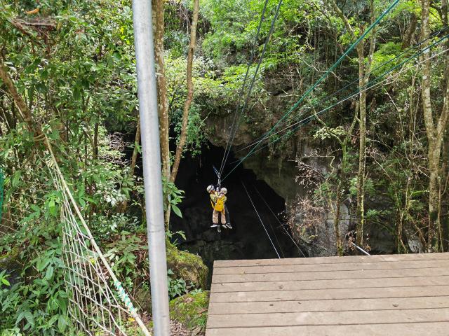 (250706) -- BEIJING, July 6, 2025 (Xinhua) -- Visitors experience a cave zipline activity at the Forest Coolpark scenic area in Libo County, southwest China's Guizhou Province, July 12, 2024. (Xinhua/Wu Si)