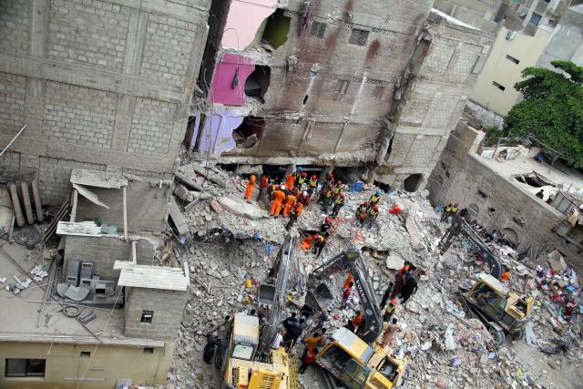 (250706) -- KARACHI, July 6, 2025 (Xinhua) -- Rescuers work at the scene of a residential building collapse in Karachi, Pakistan, July 5, 2025. The death toll in the building collapse in Pakistan's southern port city of Karachi has jumped to 27 as rescuers retrieved more bodies, a spokesperson of the state-owned rescue organization Rescue 1122 said on Sunday. (Str/Xinhua)