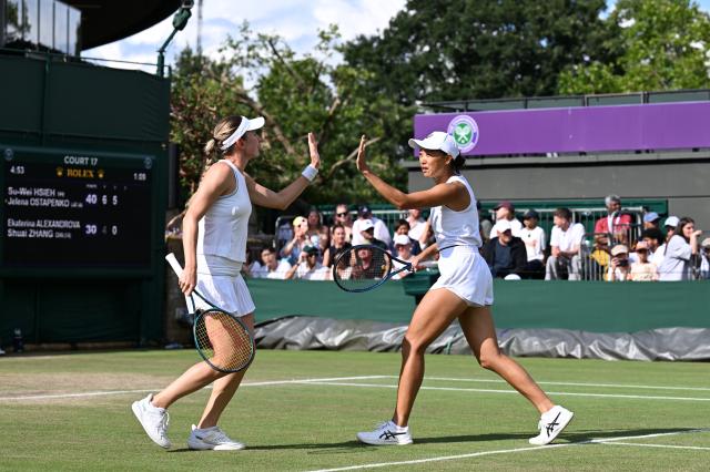 (250707) -- LONDON, July 7, 2025 (Xinhua) -- Zhang Shuai (R)/Ekaterina Alexandrova react during the women's doubles third round match between Zhang Shuai (China)/Ekaterina Alexandrova (Russia) and Hsieh Su-Wei (Chinese Taipei)/Jelena Ostapenko (Latvia) at the Wimbledon Tennis Championships in London, Britain, July 6, 2025. (Xinhua/Zhao Dingzhe)