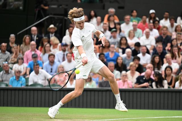 (250707) -- LONDON, July 7, 2025 (Xinhua) -- Andrey Rublev hits a return during the men's singles fourth round match between Carlos Alcaraz of Spain and Andrey Rublev of Russia at the Wimbledon Tennis Championships in London, Britain, July 6, 2025. (Xinhua/Zhao Dingzhe)