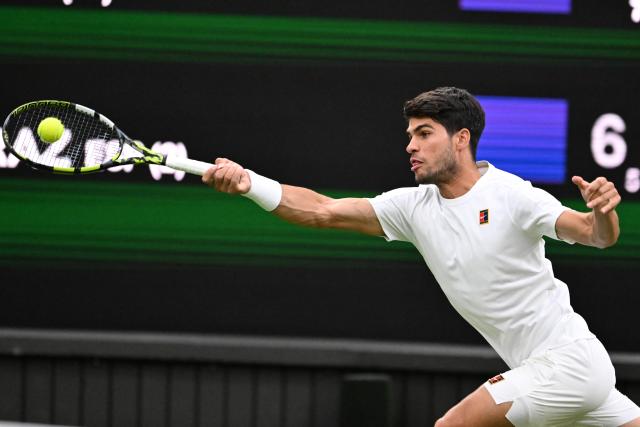 (250707) -- LONDON, July 7, 2025 (Xinhua) -- Carlos Alcaraz hits a return during the men's singles fourth round match between Carlos Alcaraz of Spain and Andrey Rublev of Russia at the Wimbledon Tennis Championships in London, Britain, July 6, 2025. (Xinhua/Zhao Dingzhe)