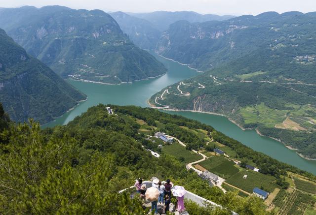 (250708) -- ENSHI, July 8, 2025 (Xinhua) -- An aerial drone photo taken on July 7, 2025 shows tourists enjoying the scenery of the Shizijiang River in Shuibuya Township of Badong County, Enshi Tujia and Miao Autonomous Prefecture, central China's Hubei Province. Enshi is a well-known summer travel destination in central China. Tapping diverse ecological resources, such as unique karst landforms, pleasant alpine climate, and dense primeval forests, the local authorities have actively developed summer tourism, and meticulously created diversified tourism products, like exploring canyon and cave, rafting on Qingjiang River and experiencing the culture of Tujia ethnic group. (Photo by Zheng Jiayu/Xinhua)