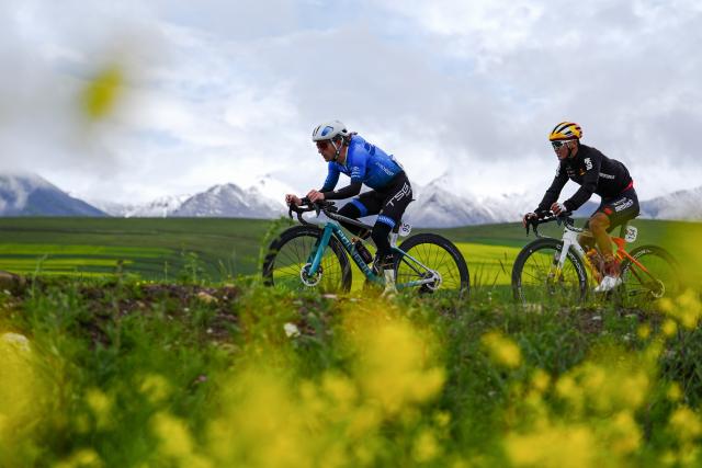 (250708) -- MENYUAN, July 8, 2025 (Xinhua) -- Adne Willemjan Van Engelen (L) of Terengganu Cycling Team and Sun Changsheng of China Anta-Mentech Cycling Team compete during the Stage 3 of the Tour of Magnificent Qinghai International Road Cycling Race from Huzhu to Menyuan, northwest China's Qinghai Province, July 8, 2025. (Xinhua/Qi Zhiyue)