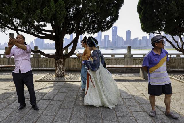 (250708) -- NANCHANG, July 8, 2025 (Xinhua) -- Tourists visit the Tengwang Pavilion scenic area in Nanchang City, east China's Jiangxi Province, on July 7, 2025. The Tengwang Pavilion, the 29th iteration in its 1,400-year history, features intricately carved beams and vibrantly painted rafters. It stands majestically along the banks of the Ganjiang River, which winds through eastern China's Jiangxi Province. About 90 percent of the scenic area has been open to the public for free as of Jan. 1 this year when a northward expansion project was fully completed. (Xinhua/Liu Jinhai)